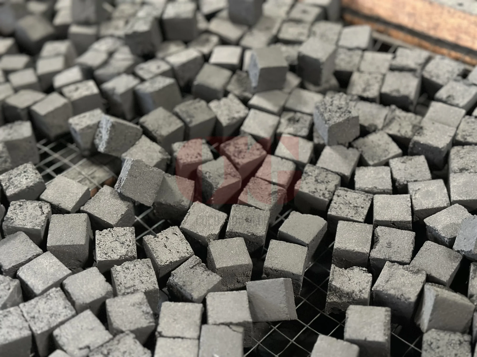 Uniform coconut shell charcoal briquettes after quality inspection.